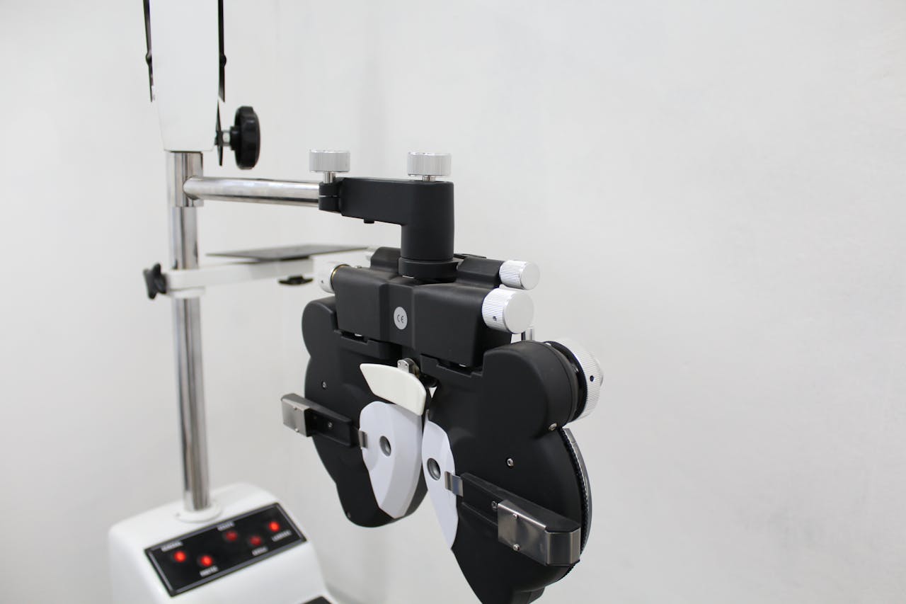 why-choose-us A phoropter used in optometry for eye examination in a bright medical office.
