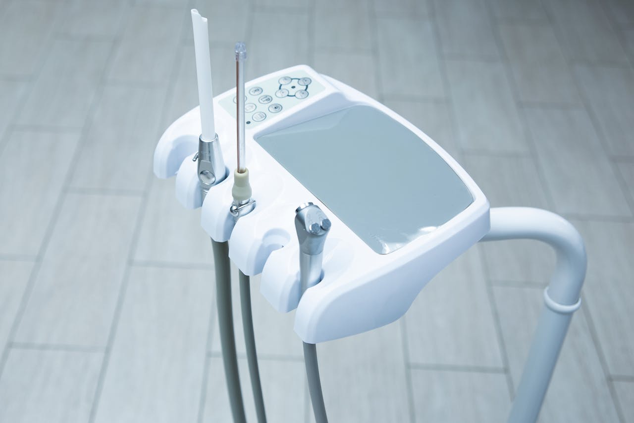 hero-img-01 Close-up of high-tech dental tools in a clean, bright clinic.